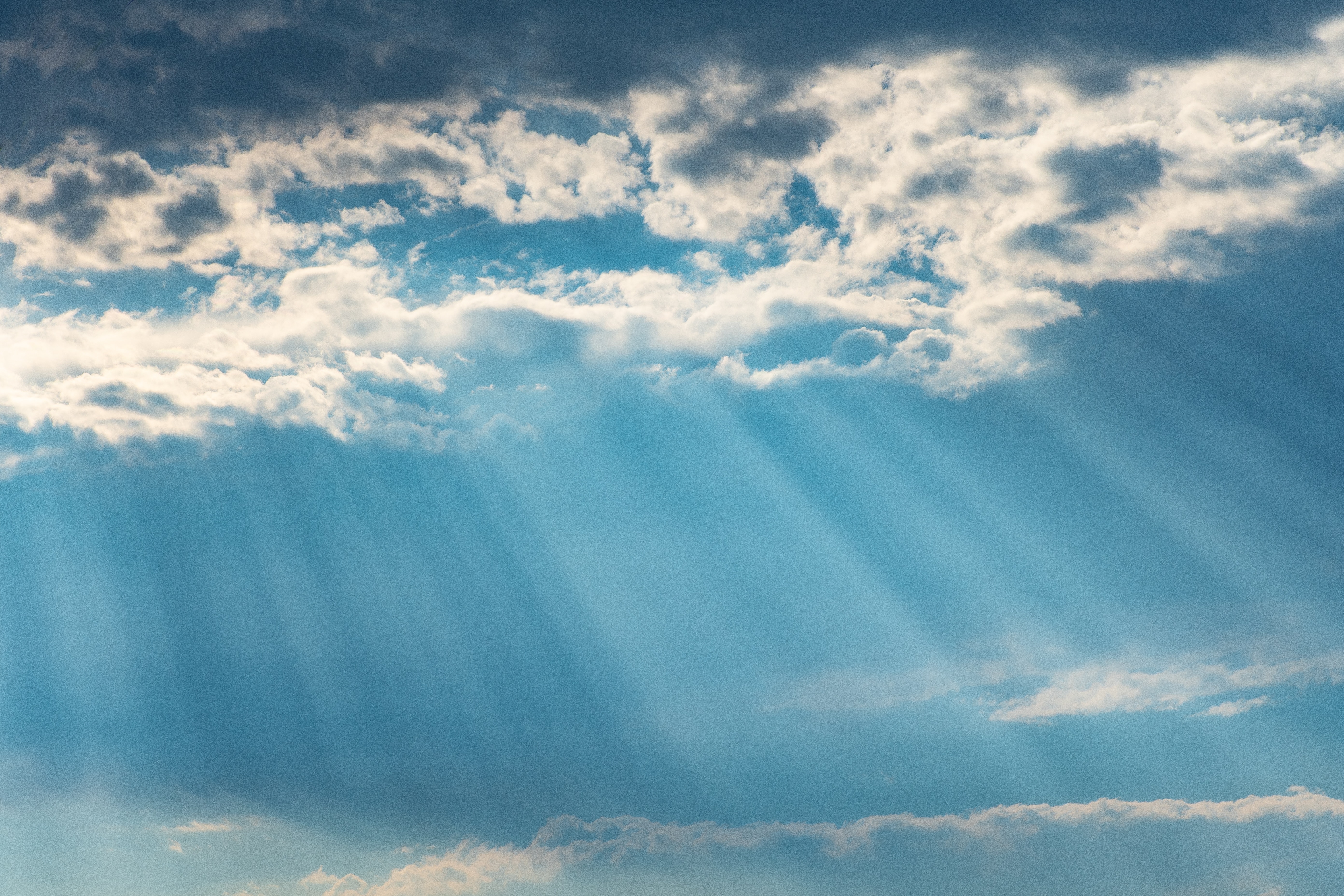 A photo of sun shining through clouds